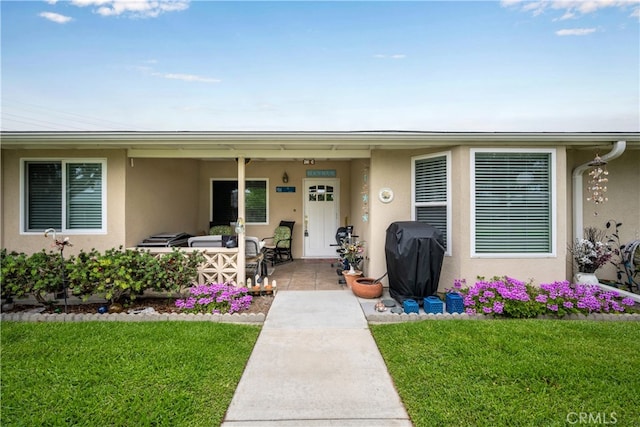 1420 Northwood Rd Unit 241C, Seal Beach, CA 90740 - view of exterior entry featuring stucco siding, a yard, and outdoor lounge area
