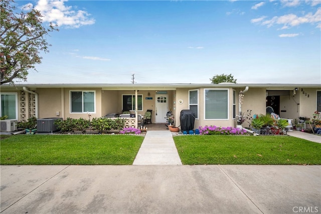 1420 Northwood Rd Unit 241C, Seal Beach, CA 90740 - ranch-style house featuring stucco siding, a front lawn, cooling unit, and ac unit