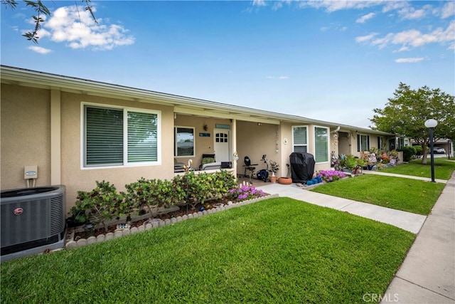 1420 Northwood Rd Unit 241C, Seal Beach, CA 90740 - ranch-style house featuring central air condition unit, stucco siding, and a front yard