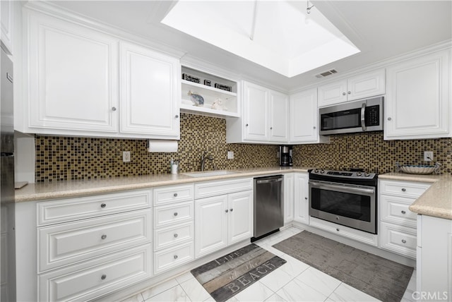 1420 Northwood Rd Unit 241C, Seal Beach, CA 90740 - kitchen with stainless steel appliances, a sink, white cabinetry, light countertops, and decorative backsplash