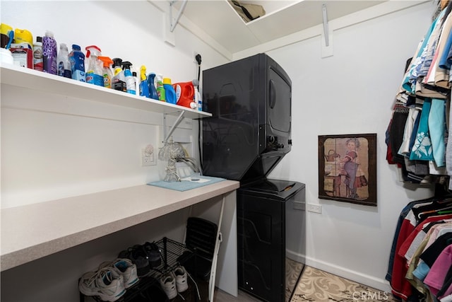 1420 Northwood Rd Unit 241C, Seal Beach, CA 90740 - laundry area featuring stacked washer / drying machine, baseboards, and light tile patterned flooring