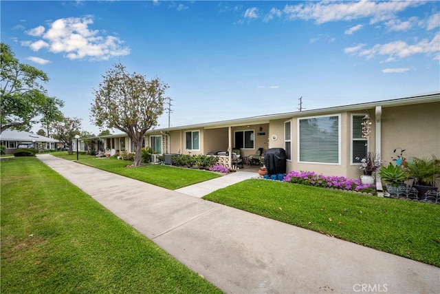 1420 Northwood Rd Unit 241C, Seal Beach, CA 90740 - view of front of home with stucco siding and a front yard