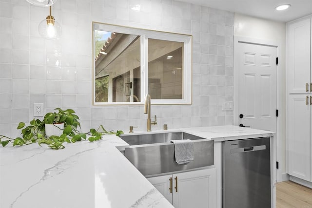 26230 N Lake Wohlford Rd, Valley Center, CA 92082 - kitchen featuring stainless steel dishwasher, a sink, white cabinetry, tile walls, and backsplash