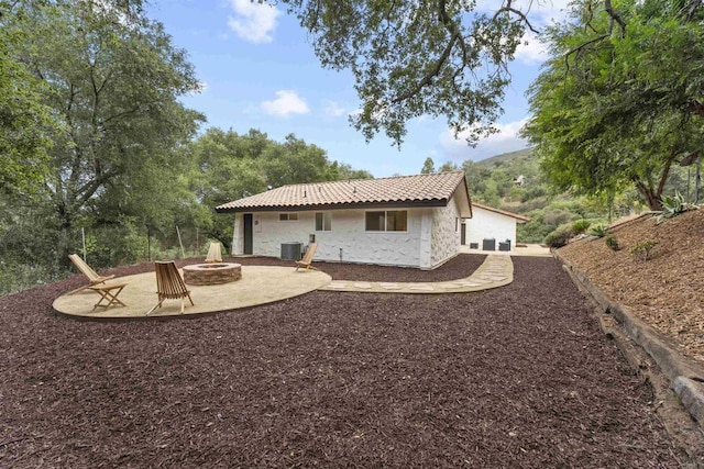 26230 N Lake Wohlford Rd, Valley Center, CA 92082 - rear view of property featuring an outdoor fire pit, stucco siding, central AC unit, a patio, and a tile roof