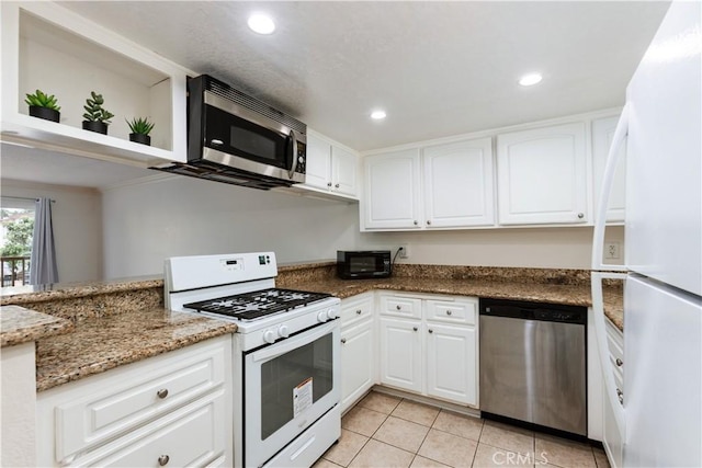 3516 E Ransom St Unit 103, Long Beach, CA 90804 - kitchen with appliances with stainless steel finishes, light tile patterned flooring, white cabinets, dark stone countertops, and recessed lighting