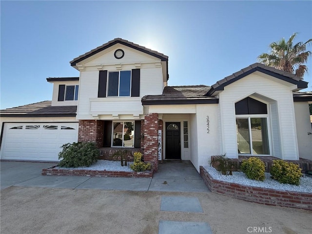 38422 Puma Ln, Palmdale, CA 93551 - view of front facade with concrete driveway, a tiled roof, and an attached garage