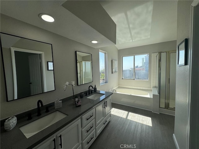 38422 Puma Ln, Palmdale, CA 93551 - bathroom featuring a garden tub, double vanity, a shower stall, wood finished floors, and recessed lighting
