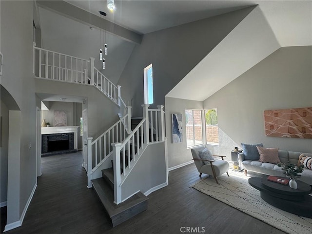 38422 Puma Ln, Palmdale, CA 93551 - living room featuring stairs, baseboards, wood finished floors, high vaulted ceiling, and a fireplace
