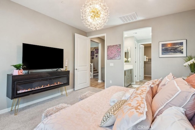 29589 Woodcreek Trl, Winchester, CA 92596 - bedroom featuring a chandelier, light carpet, baseboards, connected bathroom, and a glass covered fireplace