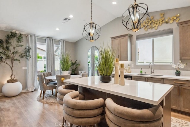 29589 Woodcreek Trl, Winchester, CA 92596 - kitchen with a chandelier, a sink, healthy amount of natural light, vaulted ceiling, and light countertops
