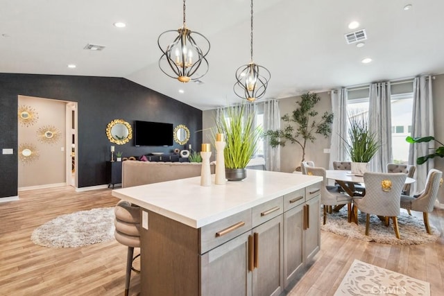 29589 Woodcreek Trl, Winchester, CA 92596 - kitchen with lofted ceiling, light wood-type flooring, a center island, decorative light fixtures, and light countertops