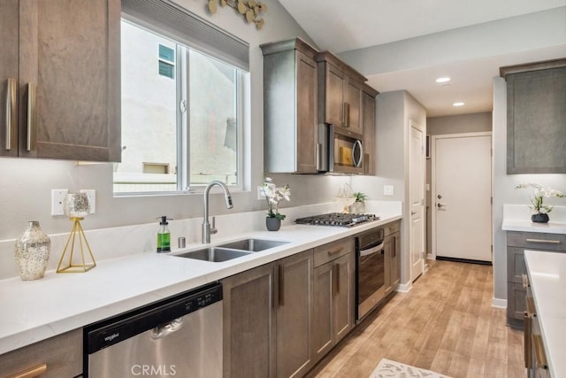 29589 Woodcreek Trl, Winchester, CA 92596 - kitchen featuring appliances with stainless steel finishes, a sink, light wood-style floors, light countertops, and recessed lighting