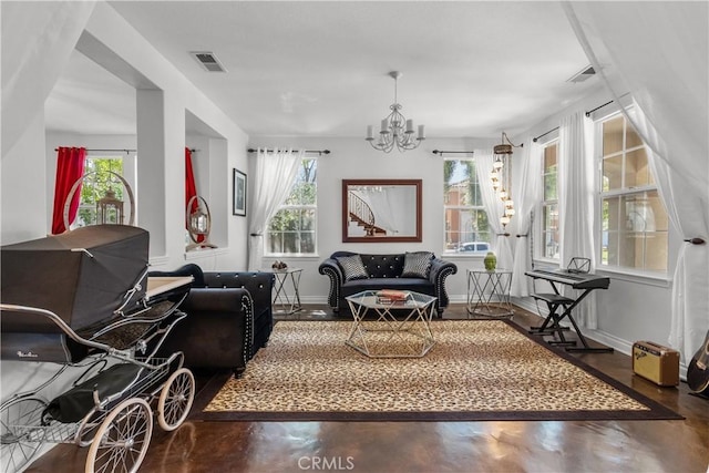 29259 Black Pine Way, Saugus, CA 91390 - living room with healthy amount of natural light, concrete flooring, a chandelier, and baseboards