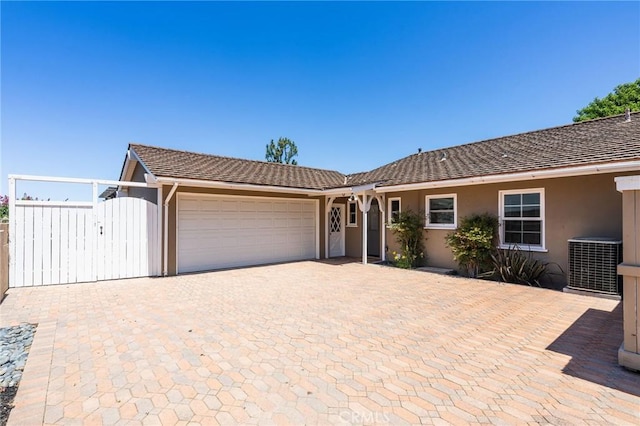 27317 Sunnyridge Rd, Palos Verdes Peninsula, CA 90274 - single story home with central AC unit, an attached garage, stucco siding, decorative driveway, and a gate