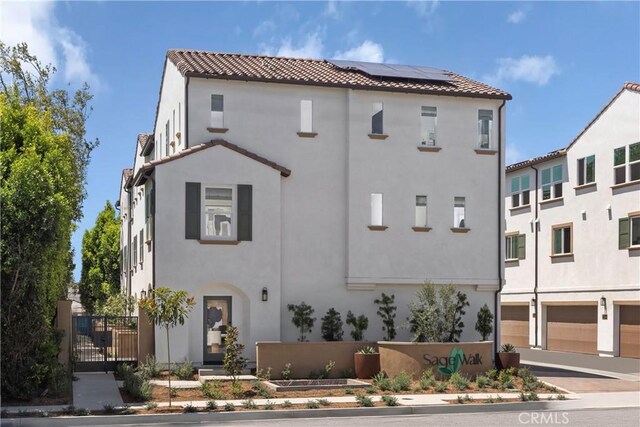 22304 Sage Ct, Torrance, CA 90502 - mediterranean / spanish house featuring roof mounted solar panels, a tile roof, and stucco siding