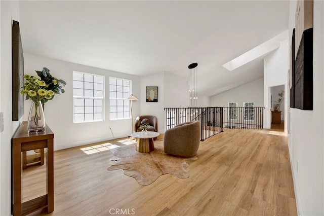 23043 Park Este, Calabasas, CA 91302 - living area featuring wood finished floors, a skylight, and vaulted ceiling