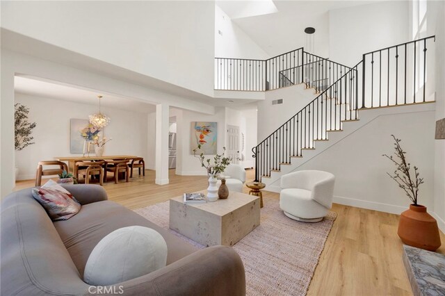 23043 Park Este, Calabasas, CA 91302 - living area featuring wood finished floors, stairs, and a towering ceiling
