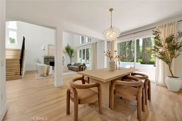 23043 Park Este, Calabasas, CA 91302 - dining space with plenty of natural light, light wood-type flooring, and a chandelier