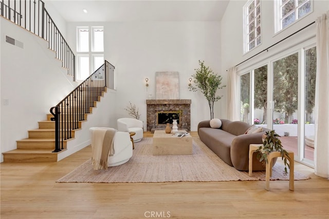 23043 Park Este, Calabasas, CA 91302 - living room featuring a high ceiling, stairway, wood finished floors, and a high end fireplace