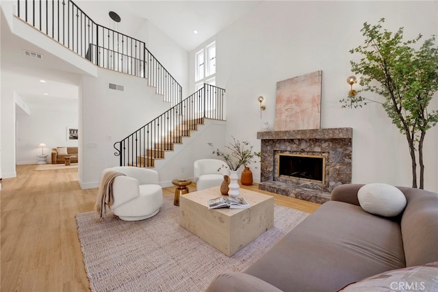 23043 Park Este, Calabasas, CA 91302 - living area with a high ceiling, wood finished floors, a fireplace, and stairway