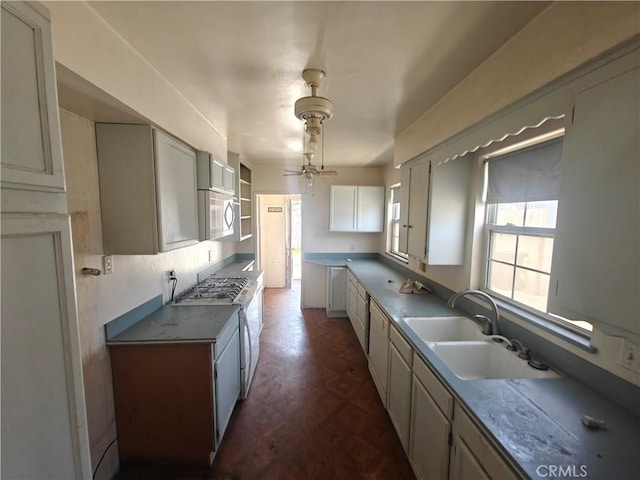 925 W Autumn Dr, Anaheim, CA 92805 - kitchen with a sink, a ceiling fan, white gas range oven, and stainless steel microwave
