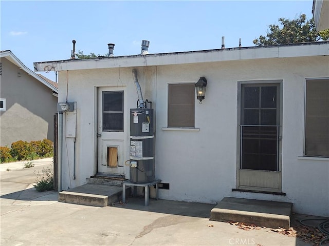 925 W Autumn Dr, Anaheim, CA 92805 - view of exterior entry featuring secured water heater and stucco siding