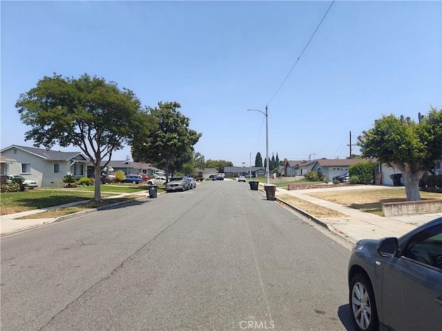 925 W Autumn Dr, Anaheim, CA 92805 - view of asphalt street with sidewalks, a residential view, curbs, and street lighting
