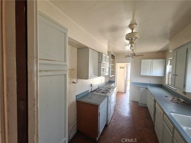 925 W Autumn Dr, Anaheim, CA 92805 - kitchen featuring white range with gas cooktop, ceiling fan, a sink, and dark wood-style floors