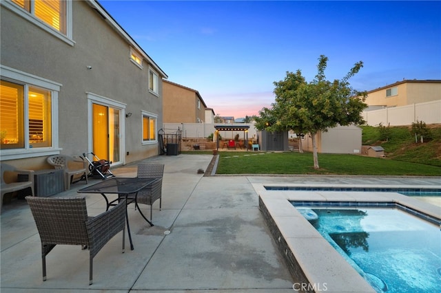 14226 Bonavento Ln, Beaumont, CA 92223 - pool at dusk with a patio and an in-ground hot tub