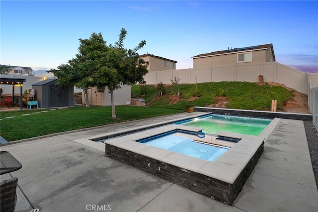 14226 Bonavento Ln, Beaumont, CA 92223 - pool at dusk with an in-ground hot tub and a patio