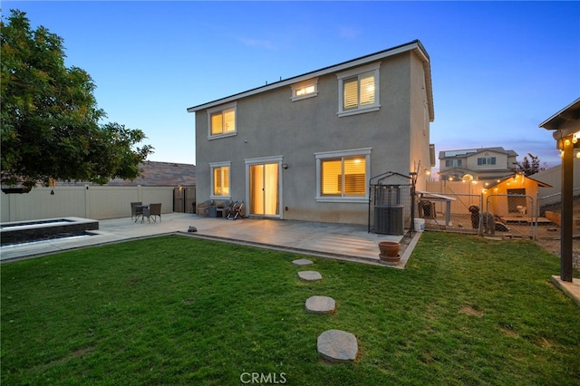14226 Bonavento Ln, Beaumont, CA 92223 - back of house at dusk with stucco siding, a patio area, and central air condition unit