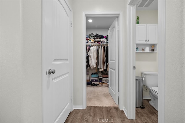 14226 Bonavento Ln, Beaumont, CA 92223 - walk in closet with dark wood-style floors