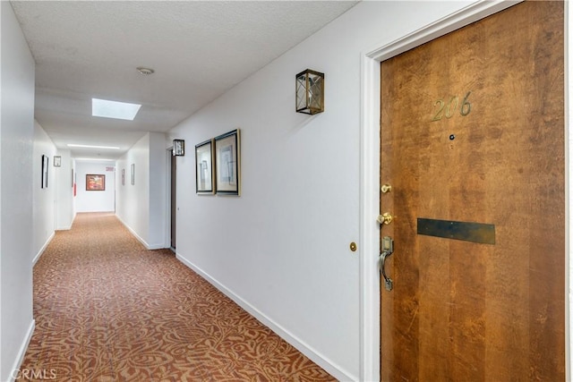 242 E Fern Ave Unit 206, Redlands, CA 92373 - corridor featuring baseboards, carpet floors, and a skylight