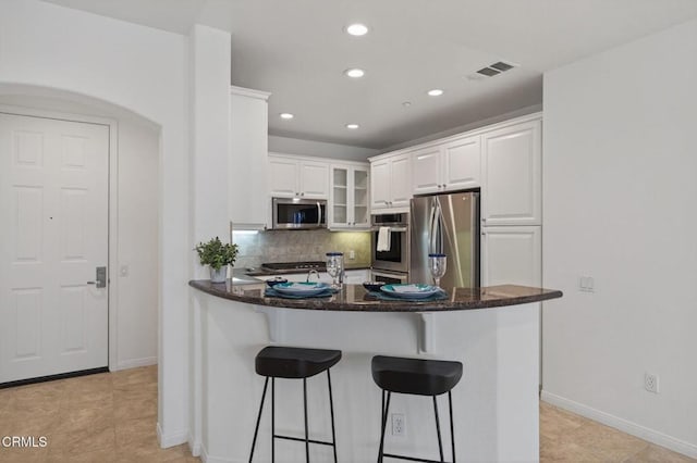 6287 Turnstone St Unit 4-304, Ventura, CA 93003 - kitchen with appliances with stainless steel finishes, a peninsula, recessed lighting, white cabinets, and backsplash