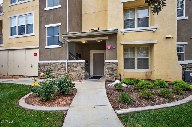 6287 Turnstone St Unit 4-304, Ventura, CA 93003 - view of exterior entry with stucco siding and stone siding