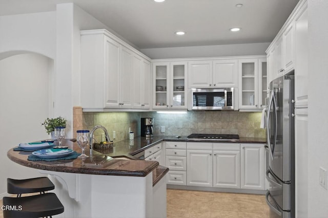 6287 Turnstone St Unit 4-304, Ventura, CA 93003 - kitchen with appliances with stainless steel finishes, a peninsula, white cabinetry, and recessed lighting