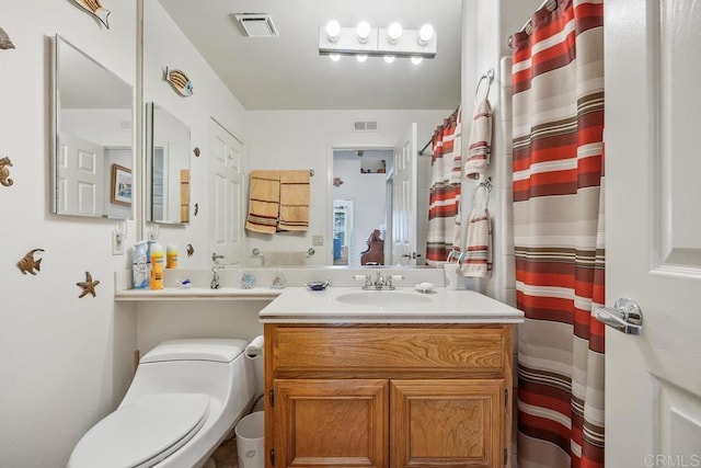 5015 Alicante Way, Oceanside, CA 92056 - bathroom with toilet, vanity, and curtained shower