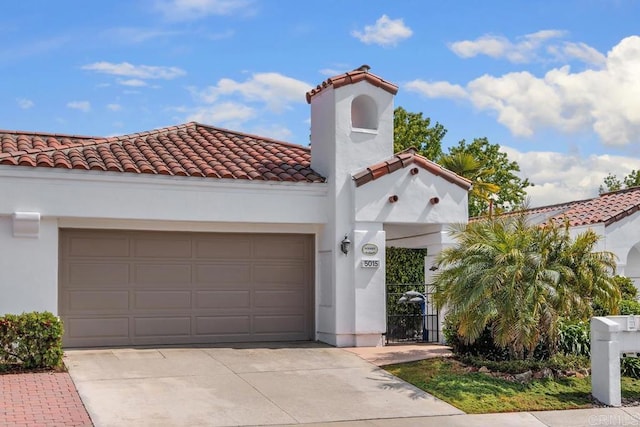 5015 Alicante Way, Oceanside, CA 92056 - mediterranean / spanish home featuring concrete driveway, a tile roof, an attached garage, and stucco siding