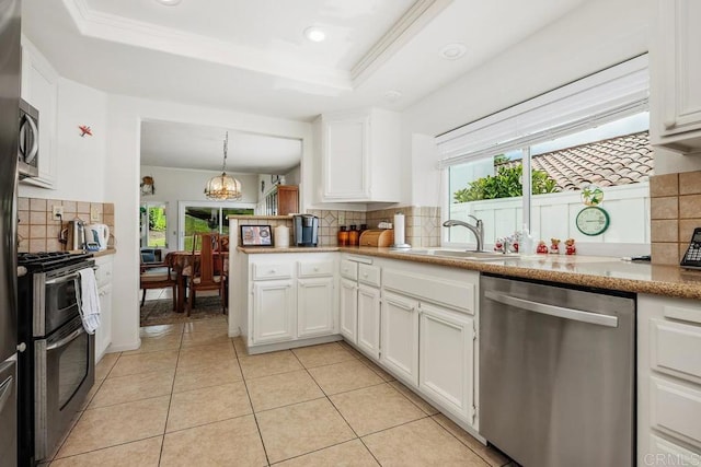 5015 Alicante Way, Oceanside, CA 92056 - kitchen featuring stainless steel appliances, a sink, decorative backsplash, white cabinets, and a chandelier