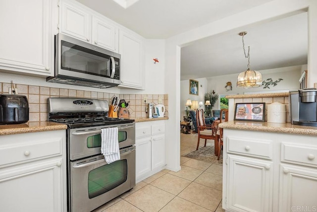 5015 Alicante Way, Oceanside, CA 92056 - kitchen with stainless steel appliances, white cabinets, and backsplash