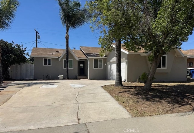 8667 Colorado Ave, Riverside, CA 92504 - single story home featuring stucco siding, an attached garage, and driveway