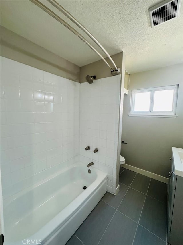 8667 Colorado Ave, Riverside, CA 92504 - bathroom featuring vanity, toilet, shower / tub combination, tile patterned floors, and a textured ceiling