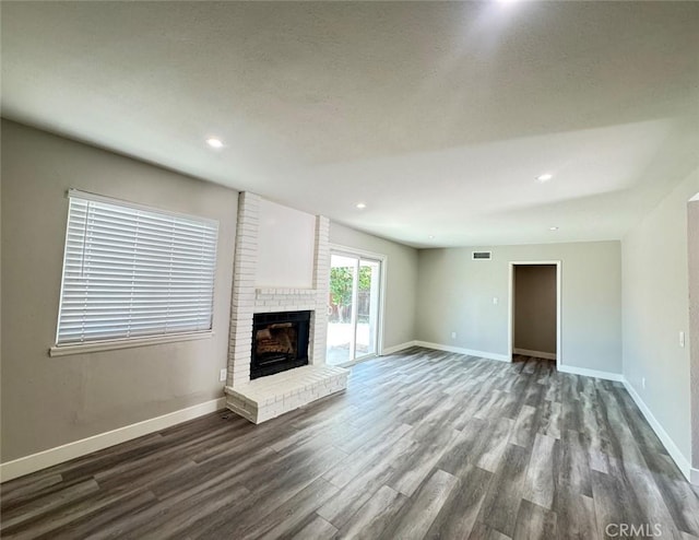 8667 Colorado Ave, Riverside, CA 92504 - unfurnished living room featuring wood finished floors, baseboards, a fireplace, and recessed lighting