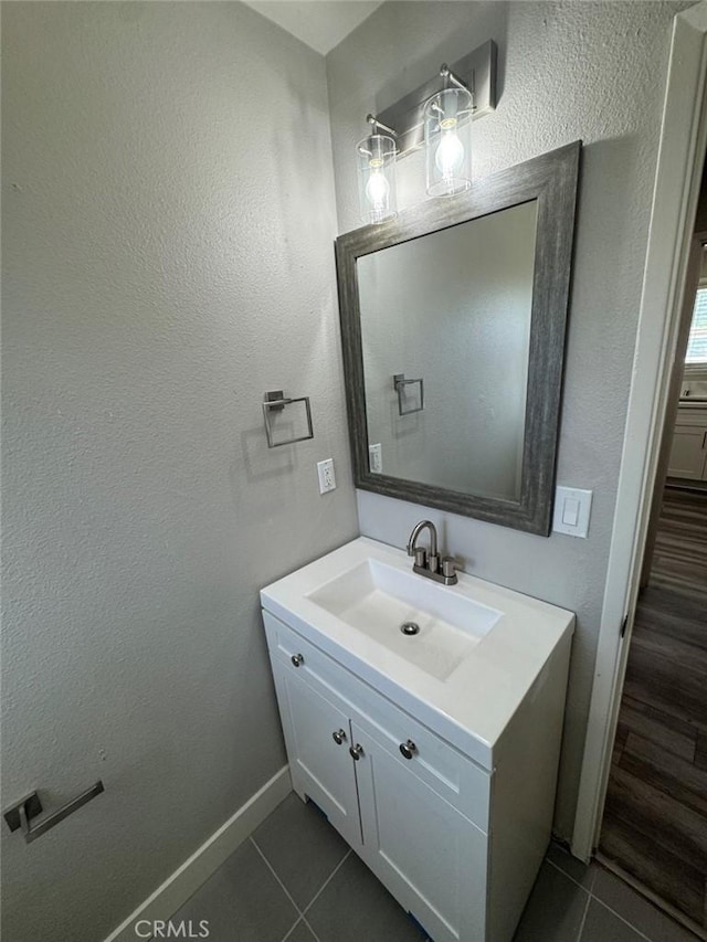 8667 Colorado Ave, Riverside, CA 92504 - bathroom with tile patterned flooring, vanity, and baseboards