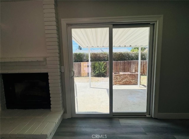 8667 Colorado Ave, Riverside, CA 92504 - doorway featuring a fireplace and baseboards