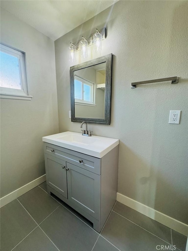 8667 Colorado Ave, Riverside, CA 92504 - bathroom with tile patterned flooring, vanity, baseboards, and healthy amount of natural light