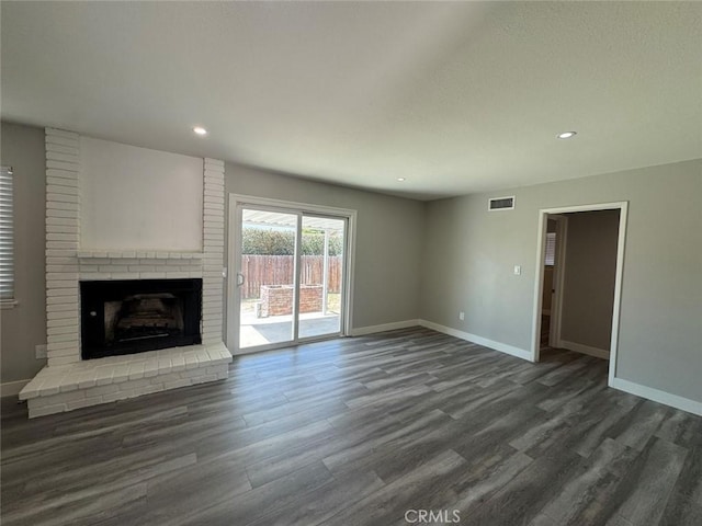 8667 Colorado Ave, Riverside, CA 92504 - unfurnished living room with baseboards, dark wood finished floors, a brick fireplace, and recessed lighting