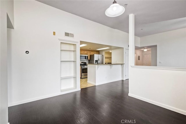 150 N River Cir Unit 306, Oceanside, CA 92057 - unfurnished living room with built in features, light wood-style floors, and baseboards