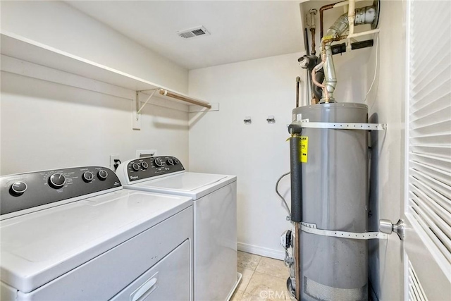 150 N River Cir Unit 306, Oceanside, CA 92057 - washroom with independent washer and dryer, secured water heater, light tile patterned flooring, and baseboards