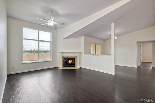 150 N River Cir Unit 306, Oceanside, CA 92057 - unfurnished living room featuring ceiling fan, a fireplace, dark wood-type flooring, baseboards, and lofted ceiling